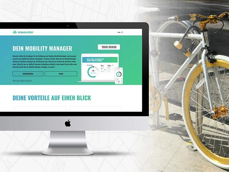Ein Bildschirm auf der Linken Seite und ein weißes Fahrrad auf der rechten Seite des Bildes. Auf dem Bidschirm steht "Dein Mobility Manager, deine Vorteile auf einen Blick"