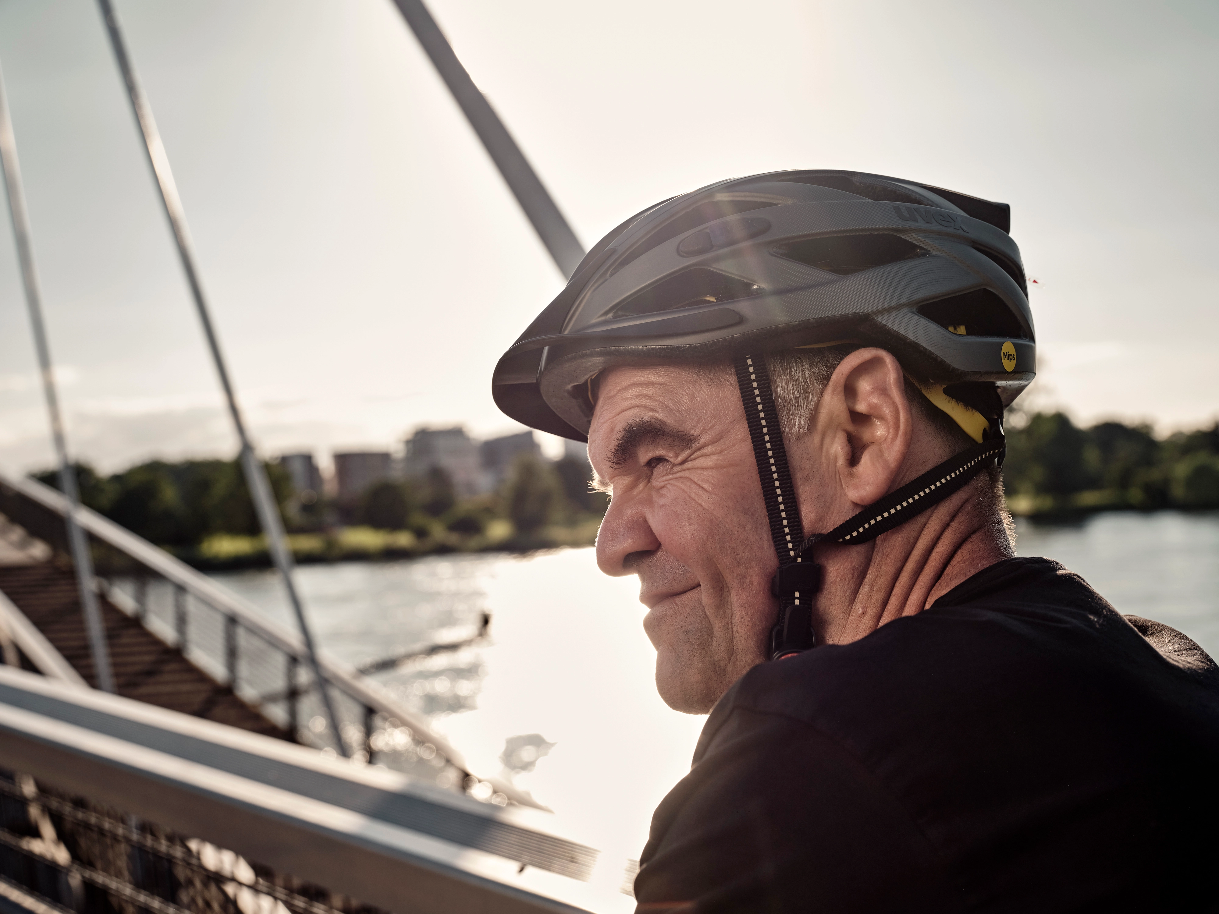 JobRadler auf Fahrradbrücke fährt grinsend in den Feierabend JobRadler auf Fahrradbrücke fährt grinsend in den Feierabend